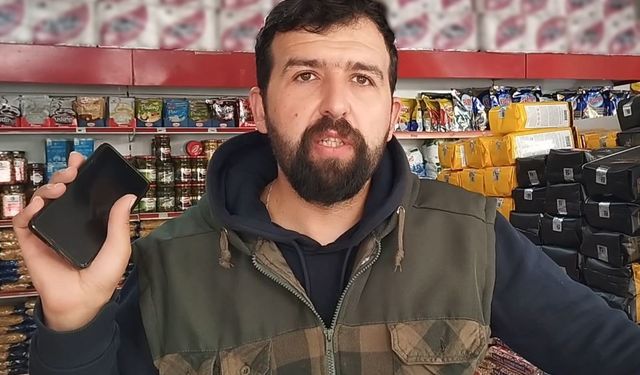 Köpek sandığı ayıyı cep telefonu ile görüntüledi